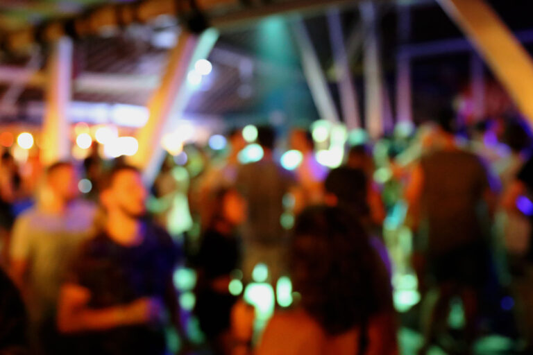 Blurred background of many people had fun at a beach party